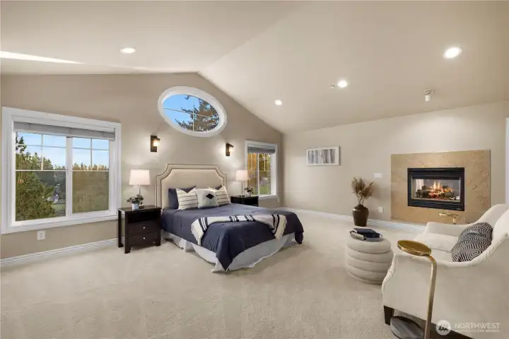 The primary bedroom is very large and features sweeping views and a gas fireplace.