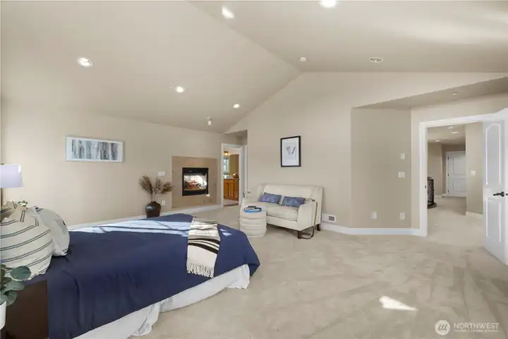 Primary suite has vaulted ceilings for a great volume of space.