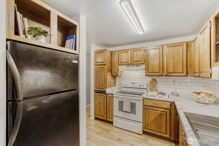 Updated countertops, tile backsplash, sink and lighting in the kitchen