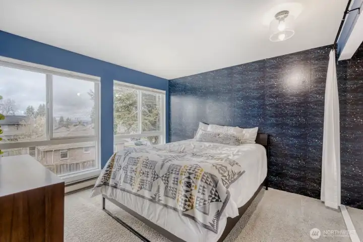 Primary bedroom bathed in natural light, and with an Olympic Mountain view.