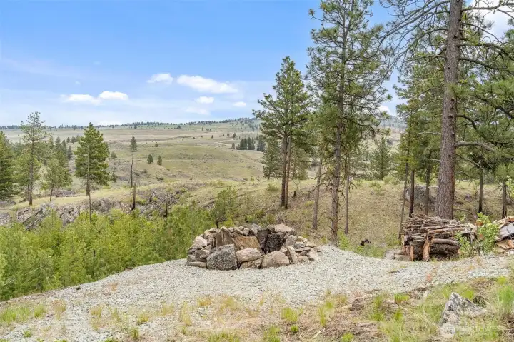 Enjoy a good campfire while overlooking a beautiful, treed canyon below.