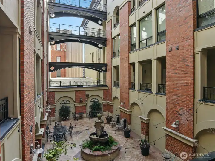 View from the Unit door.  Enjoy the open air Courtyard.  Relax by the water fountain with a good book or visit with other residents.   Lush well cared for plantings AND summer monthly concerts right out the front door to the unit!