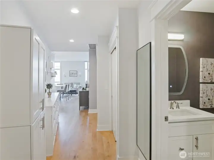 Staged View of the half bath and built-in's that line the hall.