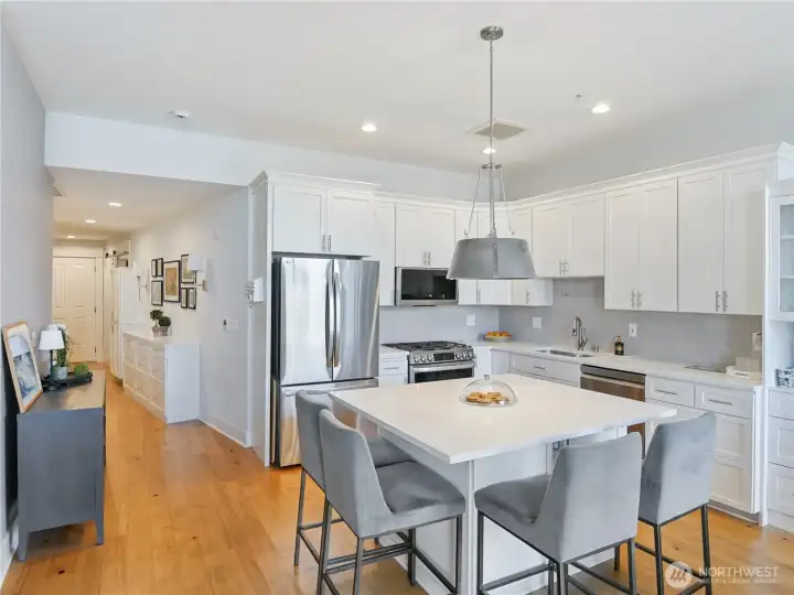 Staged View of entry hall and great room style kitchen