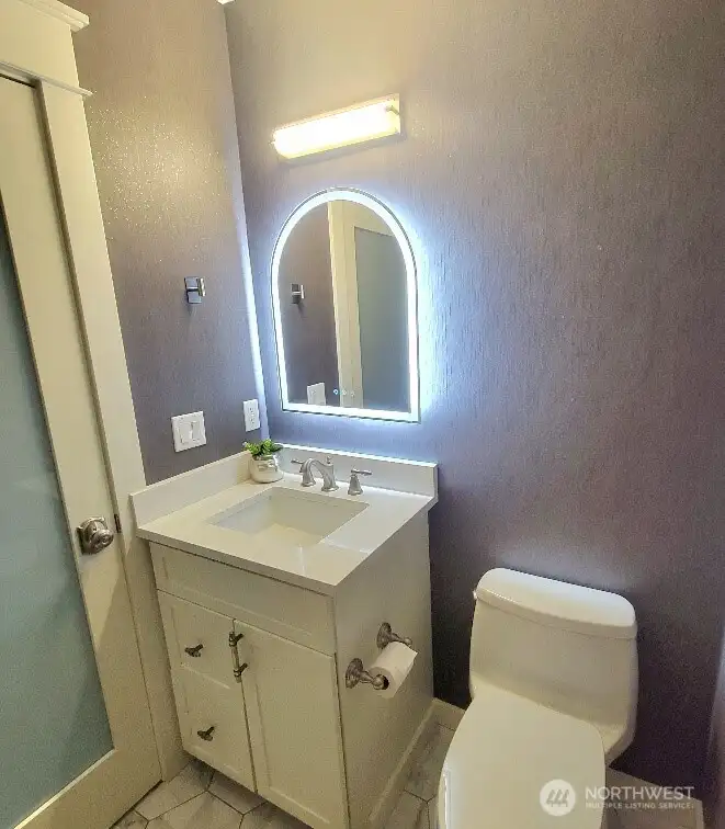1/2 bath, designer wall paper & newly installed lighted mirror