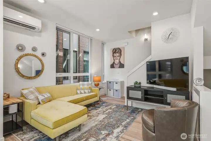 Living area with big windows and custom shades.