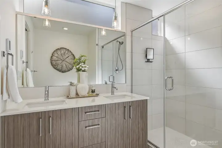 Spa-like bathroom with double sink vanity and natural light