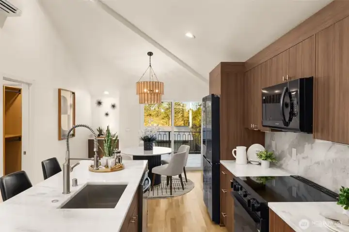 The kitchen additionally features custom walnut cabinetry & new black stainless steel Samsung appliances, poetically balancing out the white oak hardwoods