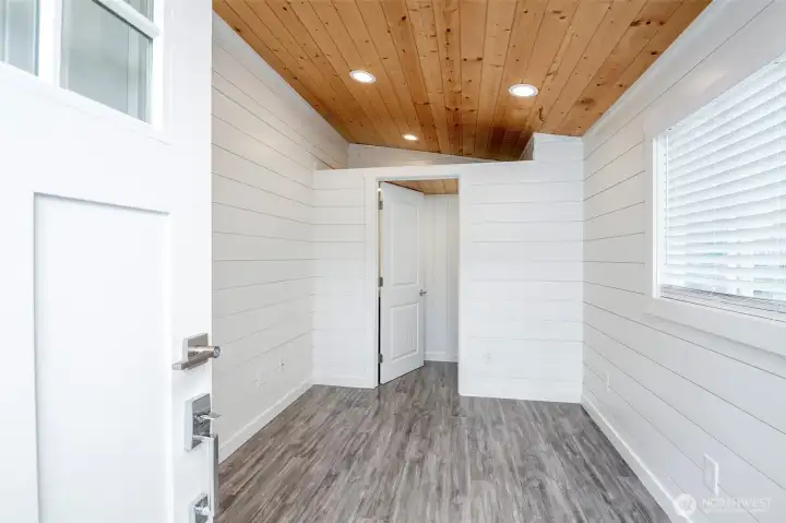 Multi-use finished den with closet, half bath and private entrance.