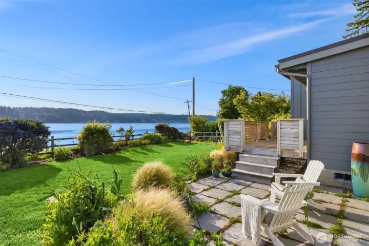 Step down from the deck to the patio and then out to the grassy area, garden and beach. Step down from the deck to the patio and then out to the grassy area, garden and beach.