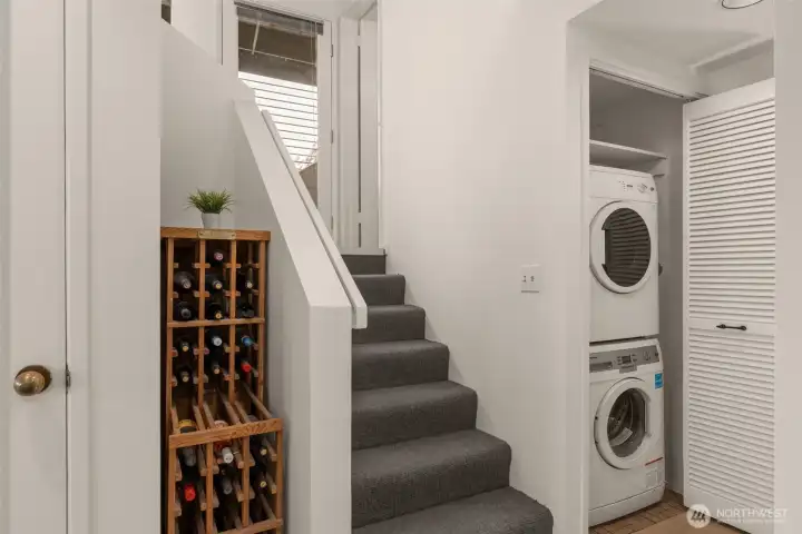 Hallway: pantry (door on the left), wine rack, and laundry