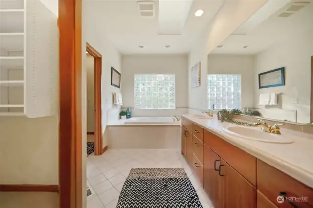 Walk in closet to the left, 5 piece spacious primary bathroom with dual vanities and large soaking tub- to the far left, walk in shower and commode.