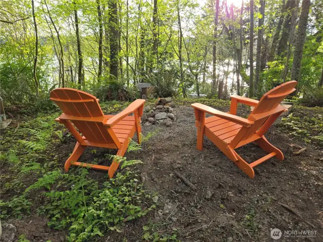 In winter, enjoy partial water and sunset views from the naturally cleared level area.  In the summer, the follage obscures the views and offers more privacy.