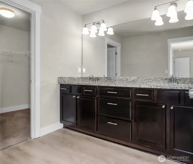 Beautiful primary bathroom featuring a dual-sink vanity, abundant storage, and a fresh, bright atmosphere.