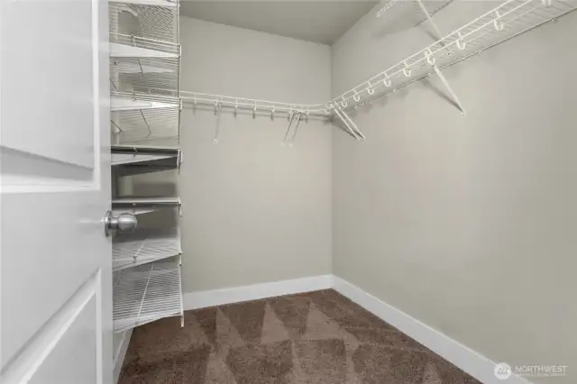 Stay organized with a walk-in closet complete with built-in shelves and ample room for all your essentials.