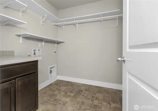 Upstairs laundry with built-in storage and folding counter to keep life organized and easy.