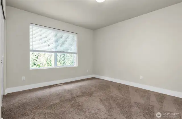 Third bedroom offers a lovely view and a spacious closet for easy storage.