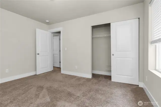Bedrooms include custom shelving for easy storage and blinds for privacy and style.