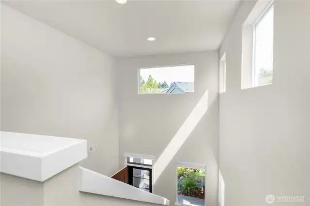 Lots of natural light fills the entry and stairway, creating a cheerful, inviting space.