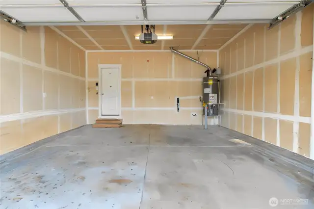 Large 2 car garage with plumbing for a future sink if you would like. The few personal items in the garage have been digitally removed.