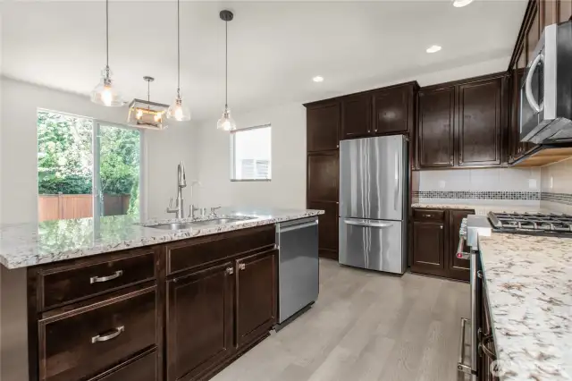 Prepare meals while staying connected to guests in the dining room and the beauty of the backyard beyond.