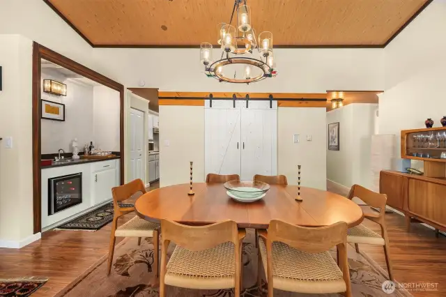 Dining room offers easy access to the kitchen and features a barn door entry to the laundry area.