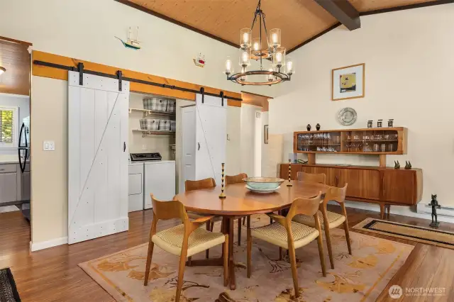 Dining room showcasing barn door entrance to laundry area.