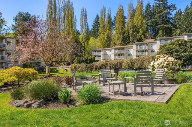 Community outdoor patio space surrounded by luscious greenery.