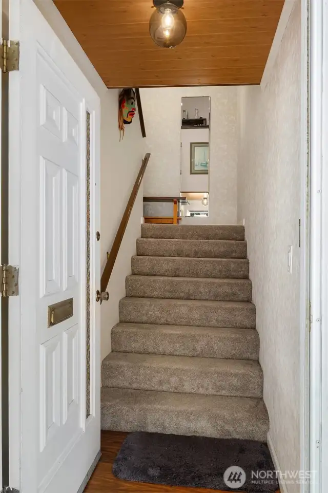 Stairs upon entry of home leading to entry foyer.