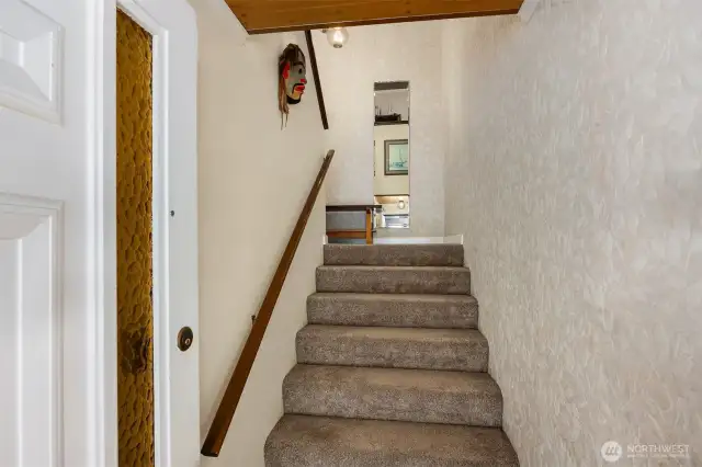 Entryway features stairs that open into a foyer.