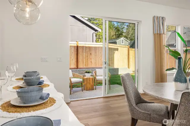 Slider door opens to patio and light filled backyard.  Photos are for illustrative purposes