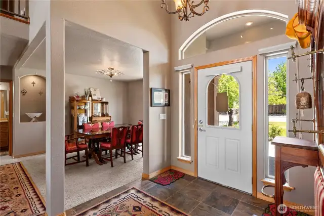 Foyer with open floor plan to dining and living room