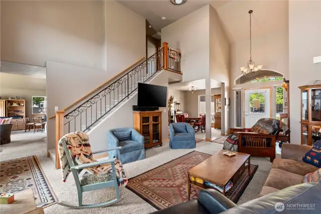 Foyer with open floor plan to dining and living room