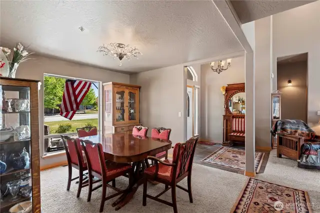 Foyer with open floor plan to dining and living room