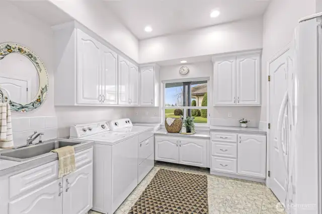 Large Laundry Room with utility sink, abundant storage and extra fridge
