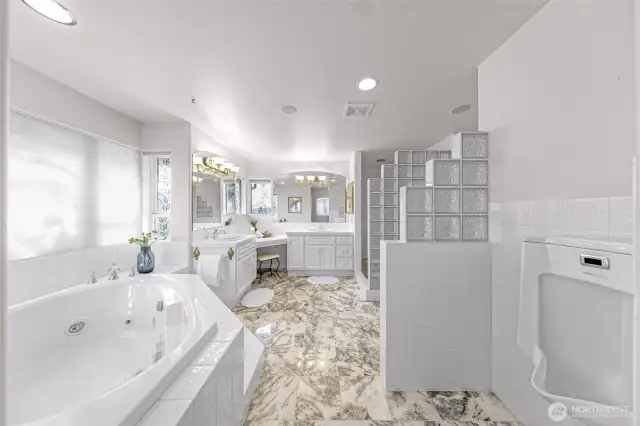 Separate jetted tub and shower with split vanities