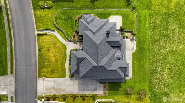 This aerial photo captures the pristine landscaping and the unique architecture of the home