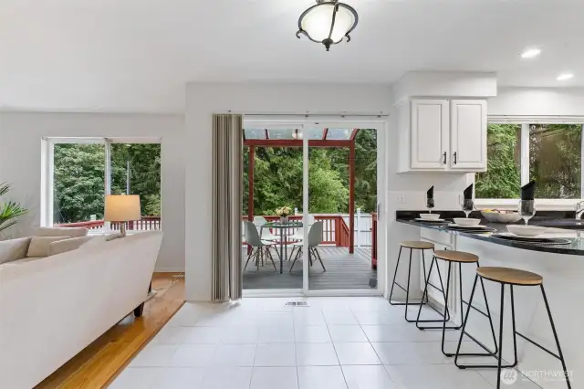 Slider off the kitchen opens to the expansive deck for seamless indoor-outdoor living.