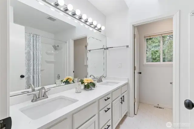 Bathroom 2 with dual sink vanity and tub/shower combo.
