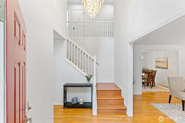Entry with soaring ceiling and hardwood floors that flow throughout the main living areas.