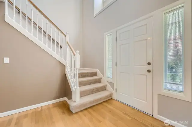 The two-story entry boasts gleaming hardwood floors, lots of light and an attractive staircase.
