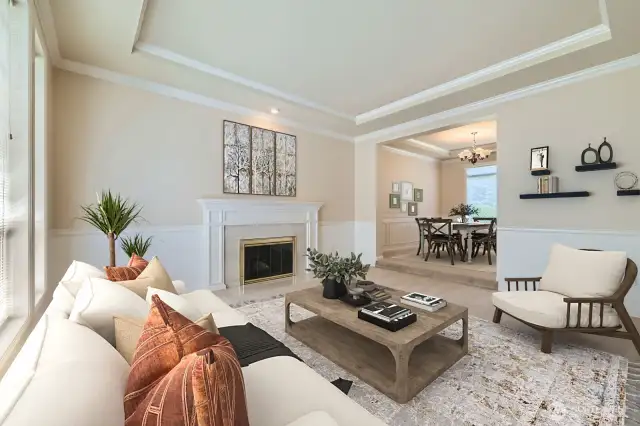The marble fireplace, coved ceilings and chair rail create a wonderful ambience to entertain guests in this spacious living room.