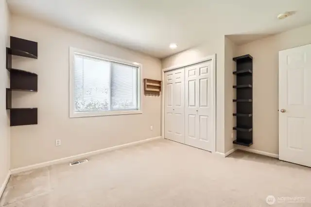 Built-in shelving and large windows are an extra bonus in this bedroom.