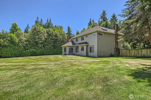 From the back play area looking toward the home, this gives you the idea of how large and sunny this beautiful yard is. '  The architectural composition roof is only 10 years old and has a transferrable warranty.