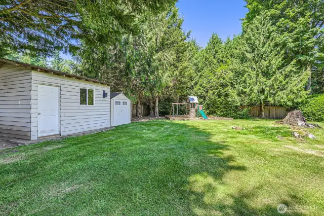 From the back play area looking toward the home, this gives you the idea of how large and sunny this beautiful yard is. '  The architectural composition roof is only 10 years old and has a transferrable warranty.