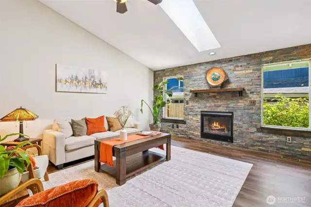 Vaulted ceilings, a skylight, and a ceiling fan give the living room a bright, airy feel.