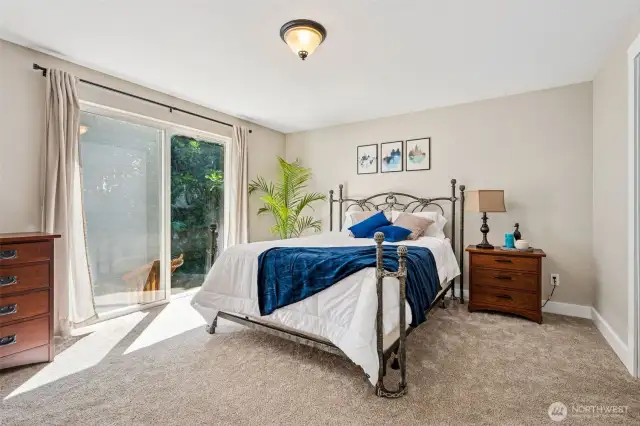 The primary bedroom features a sliding glass door that opens to the backyard, leading to a charming flagstone patio just steps away.