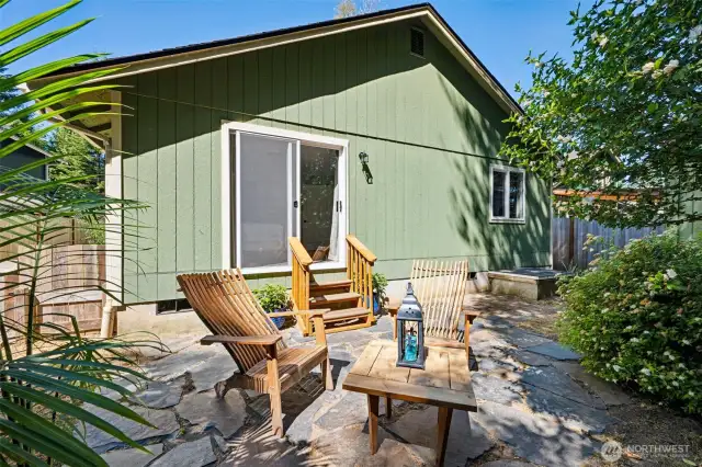 Beautifully landscaped backyard with mature greenery for added privacy and a stunning flagstone patio to enjoy the outdoors.