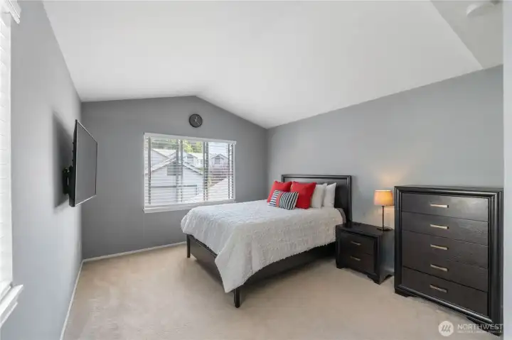 Primary bedroom with vaulted ceilings