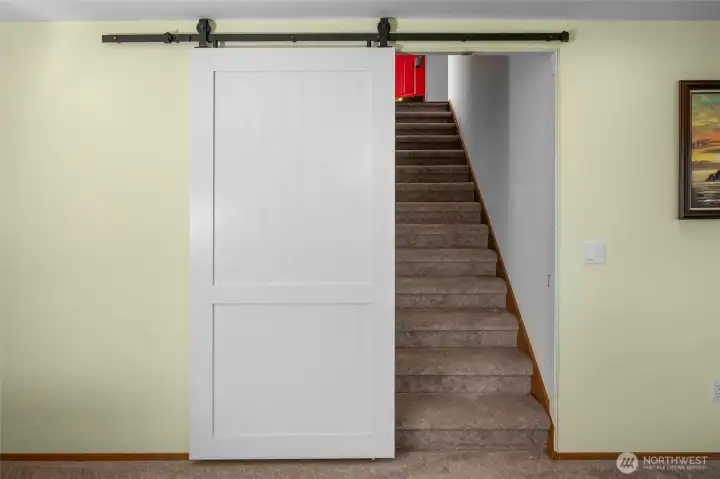 Modern barn door nicely separates the spaces.